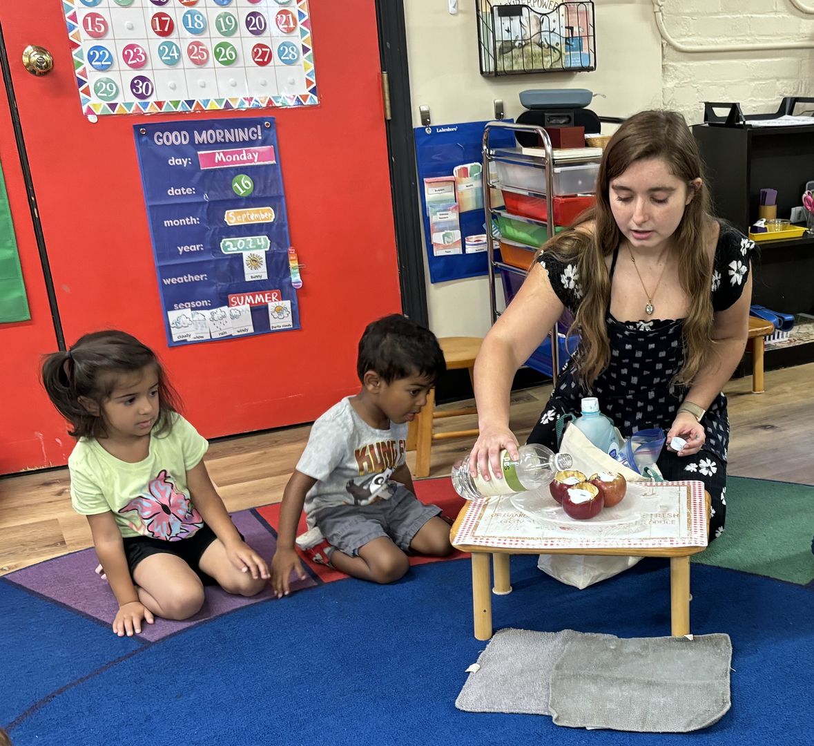 Guide working with children during snack preparation