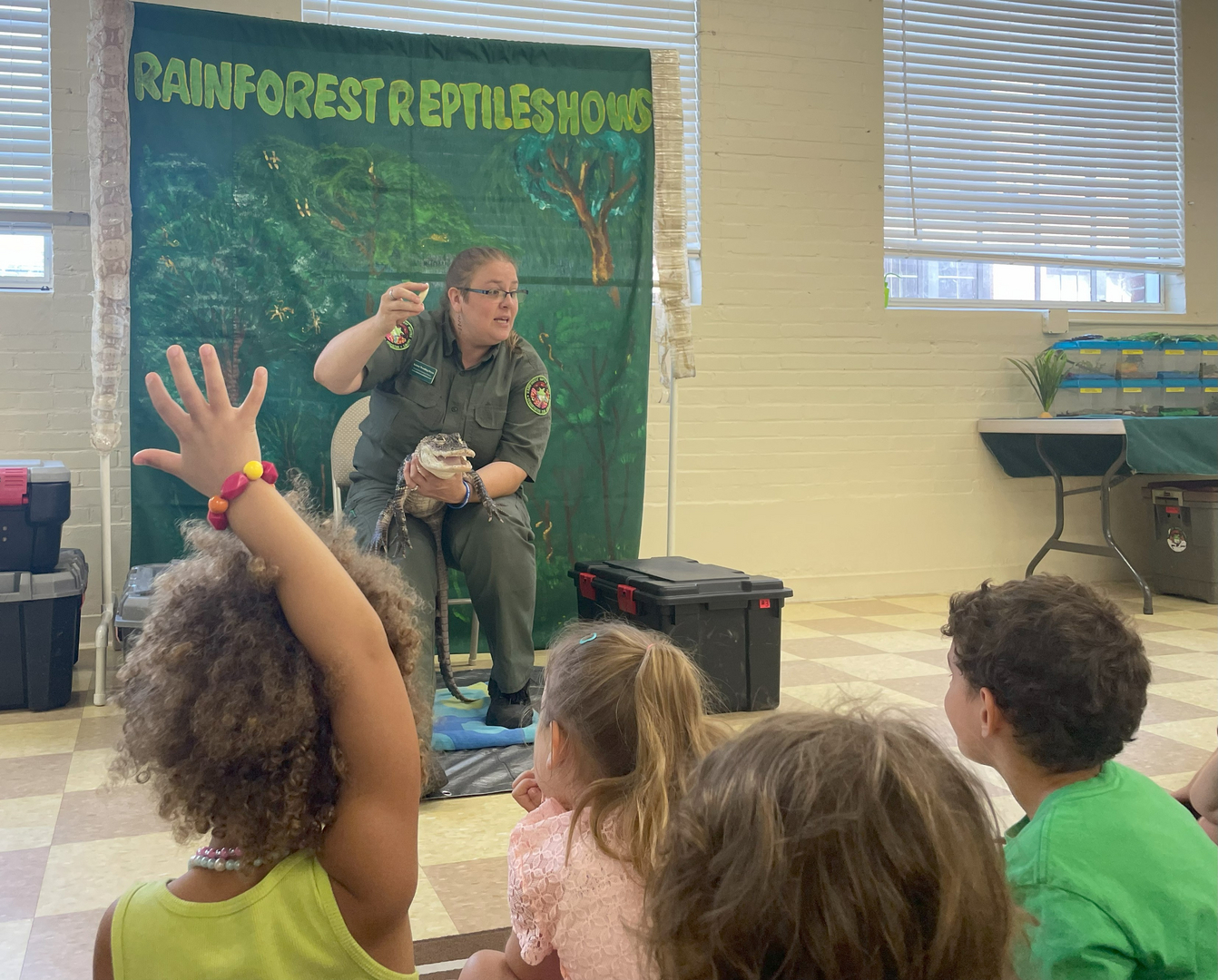 Children at the Rainforest Reptile Show school event — hands raised with excitement